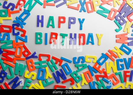 'Happy Birthday' - Refrigerator magnets spell a message out of a jumble of letters Stock Photo