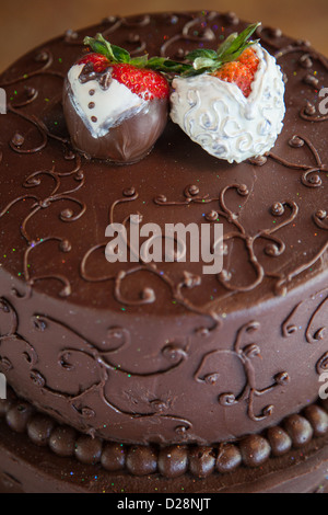 Bride and Groom strawberries on top of a chocolate wedding grooms' cake Stock Photo