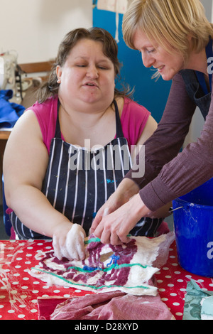 Felt making class for people with a visual impairment - feeling pocket in felted wool design. Stock Photo