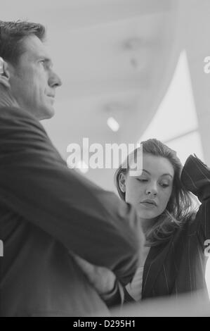 black and white business frustration stress businessman and woman stressedLicense free except ads and outdoor billboards Stock Photo