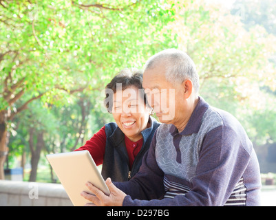 happy asian Senior couple with tablet pc