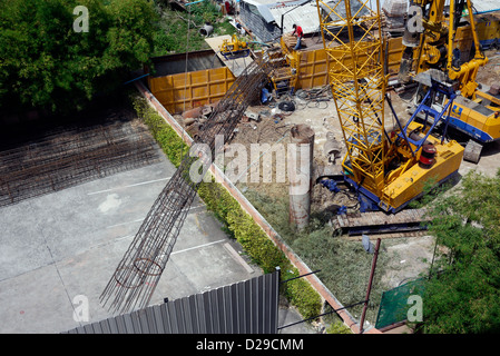 Heavy equipment laying foundations on a Construction Site in Pattaya Thailand Stock Photo