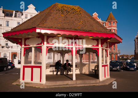 Elderly Couple Sat In A Shelter On Bexhill Seafront East Sussex UK Stock Photo
