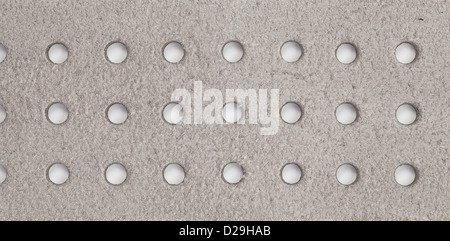 Close up photo of white leather. Leather is perforated by round holes. Stock Photo