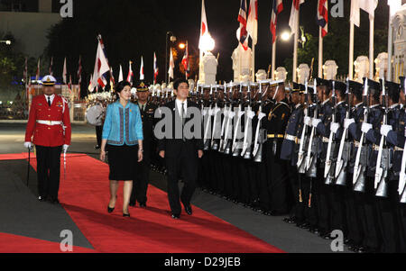 17th Jan 2013. Bangkok, Thailand. Shinzo Abe, Japan's prime minister and Yingluck Shinawatra, Thailand's prime minister review an honor guard during a welcoming ceremony at Government House. Abe becomes first Japanese Prime Minister to visit Thailand in 11 years . The Japanese prime minister arrived in Thailand on Thursday.He visited Thai-Nichi Institute of Technology and was granted an audience with His Majesty the King at Her Royal Highness Princess Galyani Vadhana Auditorium at Siriraj Hospital before holding talks with Ms Yingluck at Government House. Stock Photo