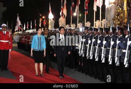 17th Jan 2013. Bangkok, Thailand. Shinzo Abe, Japan's prime minister and Yingluck Shinawatra, Thailand's prime minister review an honor guard during a welcoming ceremony at Government House. Abe becomes first Japanese Prime Minister to visit Thailand in 11 years . The Japanese prime minister arrived in Thailand on Thursday.He visited Thai-Nichi Institute of Technology and was granted an audience with His Majesty the King at Her Royal Highness Princess Galyani Vadhana Auditorium at Siriraj Hospital before holding talks with Ms Yingluck at Government House. . Stock Photo