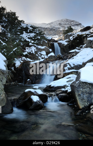 Waterfalls on Levers Water Beck with the Old Man of Coniston in the background Stock Photo