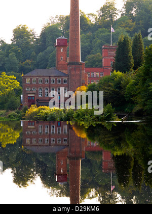 Masson Mill a former cotton mill now a shopping centre reflected in River Derwent at Matlock Bath Derbyshire Peak District UK Stock Photo