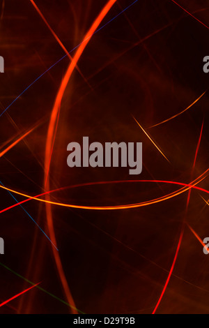 Red and orange light trails against a black background Stock Photo