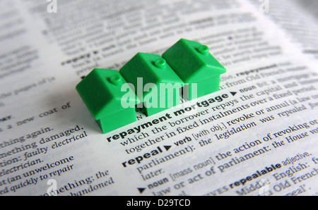MODEL HOUSES ON DICTIONARY WITH WORD REPAYMENT MORTGAGE RE HOME BUYERS MORTGAGES DEBT INCOME JOB LOSS REDUNDANCY WAGES  DEBTS UK Stock Photo
