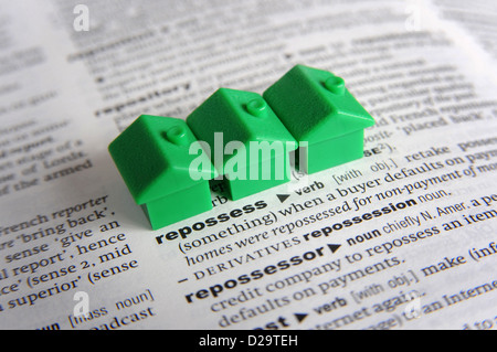 MODEL HOUSES ON DICTIONARY WITH WORD REPOSSESS  RE HOME BUYERS MORTGAGES DEBT INCOME JOB LOSS REDUNDANCY WAGES PAY DEBTS CASH UK Stock Photo