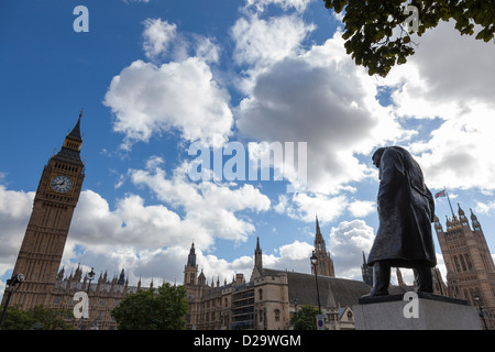 The statue of Winston Churchill in Parliament Square, London, looks towards Big Ben and the Palace of Westminster beyond. Stock Photo