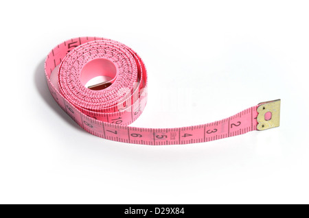 Pink dressmakers tape measure on white background Stock Photo