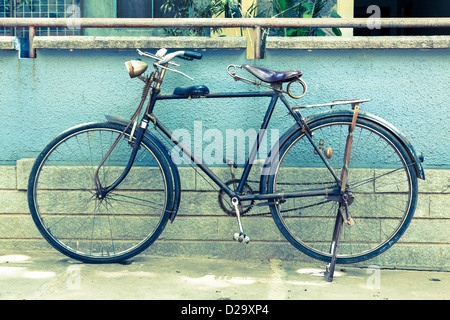 Vintage retro bicycle in India, cross-processed toned image Stock Photo