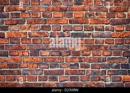 Old weathered red brick wall as background Stock Photo