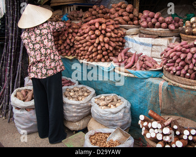 An unidentified woman sells vegetables in an open market on December 6, 2008 in Da Lat, Vietnam Stock Photo