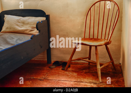 An antique chair and bed. Stock Photo