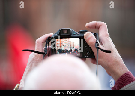 Bald headed man takes photo looking at camera LCD Stock Photo