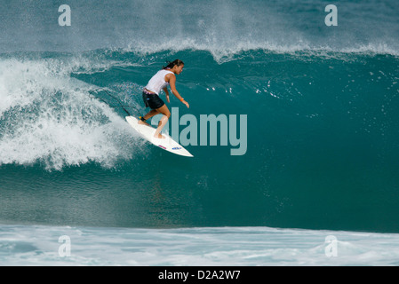 Hawaii, Oahu. Girl Surfing 'Gas Chambers'. Stock Photo