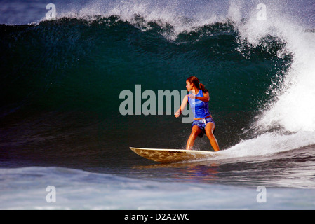 Hawaii, Oahu. Girl Surfing At 'Gas Chambers' Stock Photo