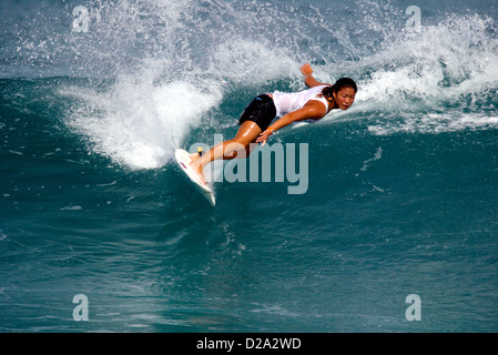 Hawaii, Oahu. Girl Surfing At 'Gas Chambers' Stock Photo