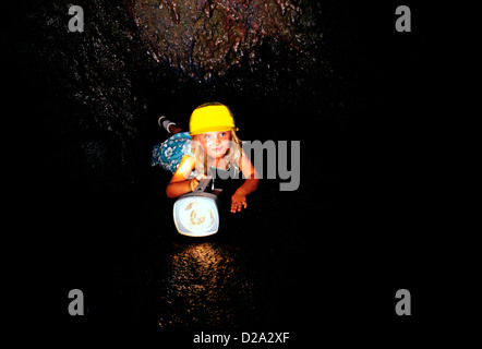 Girl Exploring Cave Stock Photo