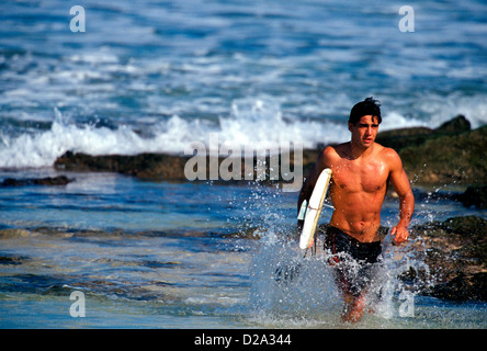 Hawaii, Oahu. Surfer With Broken Surf Board. Rocky Point. Stock Photo