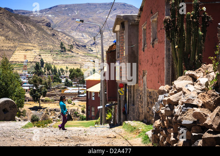 Woman walk on the road near the town of Chivay in Peru Stock Photo