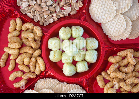Closeup of selection of snacks on red background. Stock Photo
