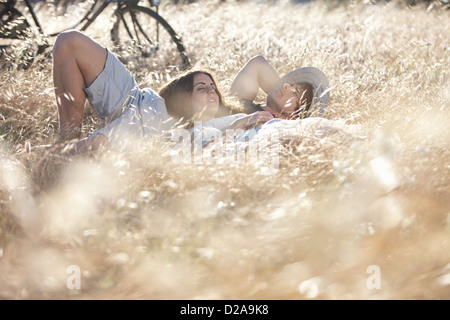 Couple laying in tall grass Stock Photo