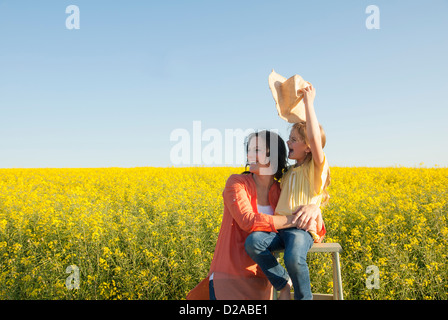 Mother and daughter in field of flowers Stock Photo