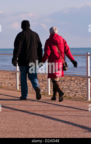 Rear View Of A Middle Aged Man and Woman Walking Wearing Coats Stock Photo
