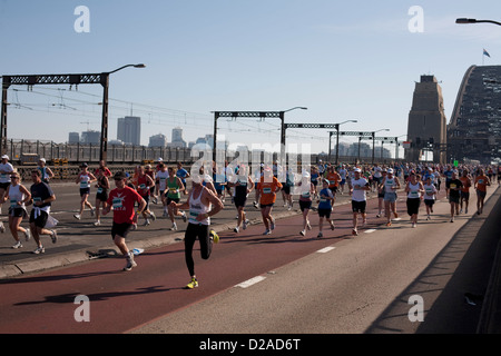 Fitness enthusiasts taking part in the Sydney Charity fun run across the Sydney Harbour Bridge Stock Photo