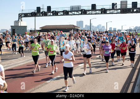 Thousands of fitness enthusiasts running across the Sydney Harbour Bridge in a charity fun run Sydney Australia Stock Photo