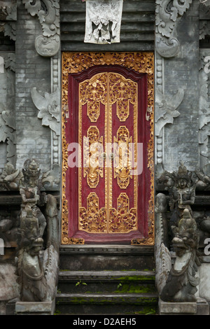 Entrance to indonesia hindu temple with carved wooden door. Stock Photo