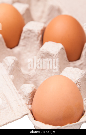 many fresh yellow chicken eggs in container Stock Photo