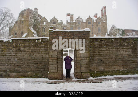 Woman taking photograph of Jacobean Hay Castle covered in snow. Hay-on-Wye Powys Wales UK. 18th January 2013. Credit: Jeff Morgan/Alamy Live News Stock Photo