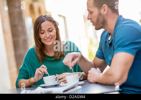 Couple having coffee at sidewalk cafe Stock Photo