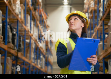 Worker checking stock in warehouse Stock Photo