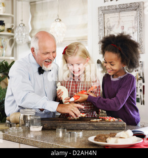 Family baking Christmas cookies together Stock Photo