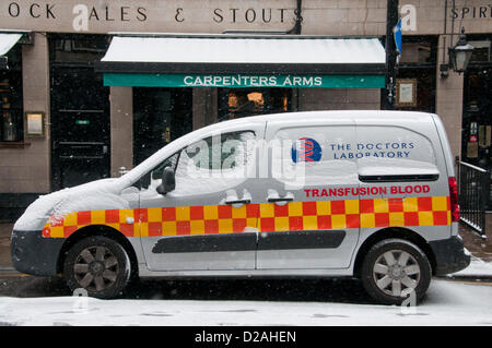 London, UK. 18/01/13. A blood transfusion van is covered in a layer of snow, as snow falls in Central London. Stock Photo