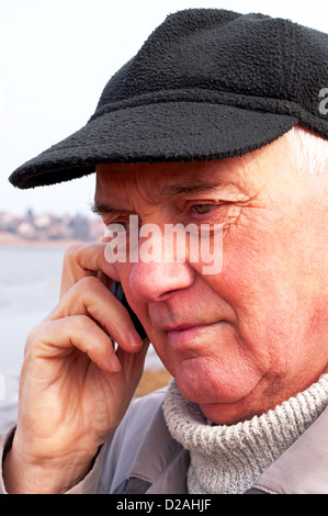 Senior man is talking on cell phone Stock Photo