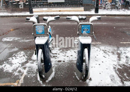 London, UK. 18/01/13. Two Barclays Bikes or Boris Bikes covered in snow, as snow falls in Central London. Stock Photo