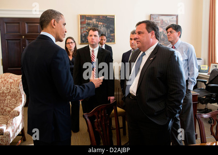 US President Barack Obama greets New Jersey Governor Chris Christie and members of his staff in Chief of Staff Jack Lew's office in the West Wing of the White House December 6, 2012 in Washington, DC. Stock Photo