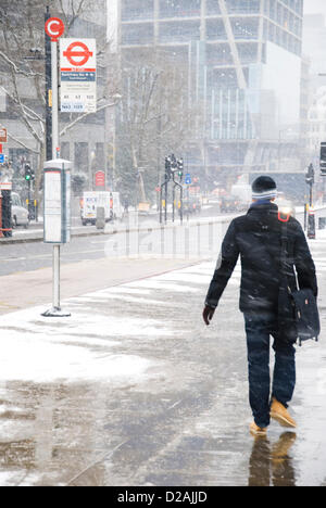 London, UK. 18th Jan, 2013. People battle the weather as snow falls on London. Stock Photo