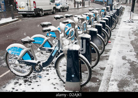 London, UK. 18/01/13. A row of Barclays Bikes or Boris Bikes covered in snow, as snow falls in Central London. Stock Photo