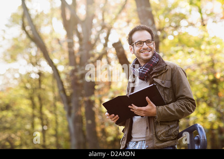 Man using tablet computer in forest