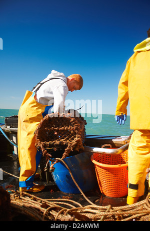 Fishermen at work on boat Stock Photo