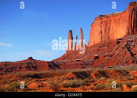 The Three Sisters rock formation found in the Navajo nation land of Monument Valley Stock Photo