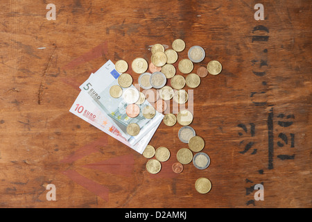 Euro coins and notes on table Stock Photo